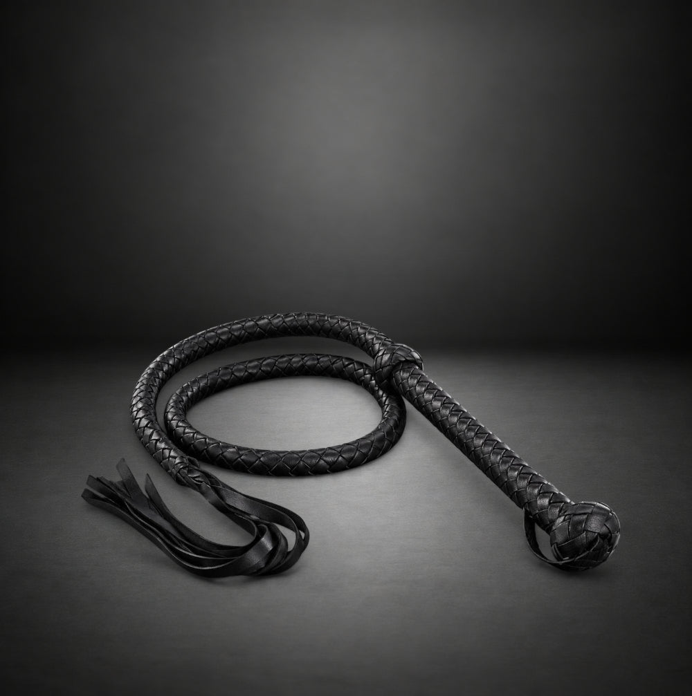 RealCock Toys black braided faux leather bullwhip with knotted handle and fringed tail for BDSM play